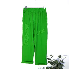 Linen trousers with embroidery anglaise elements on directional stitching with pockets
