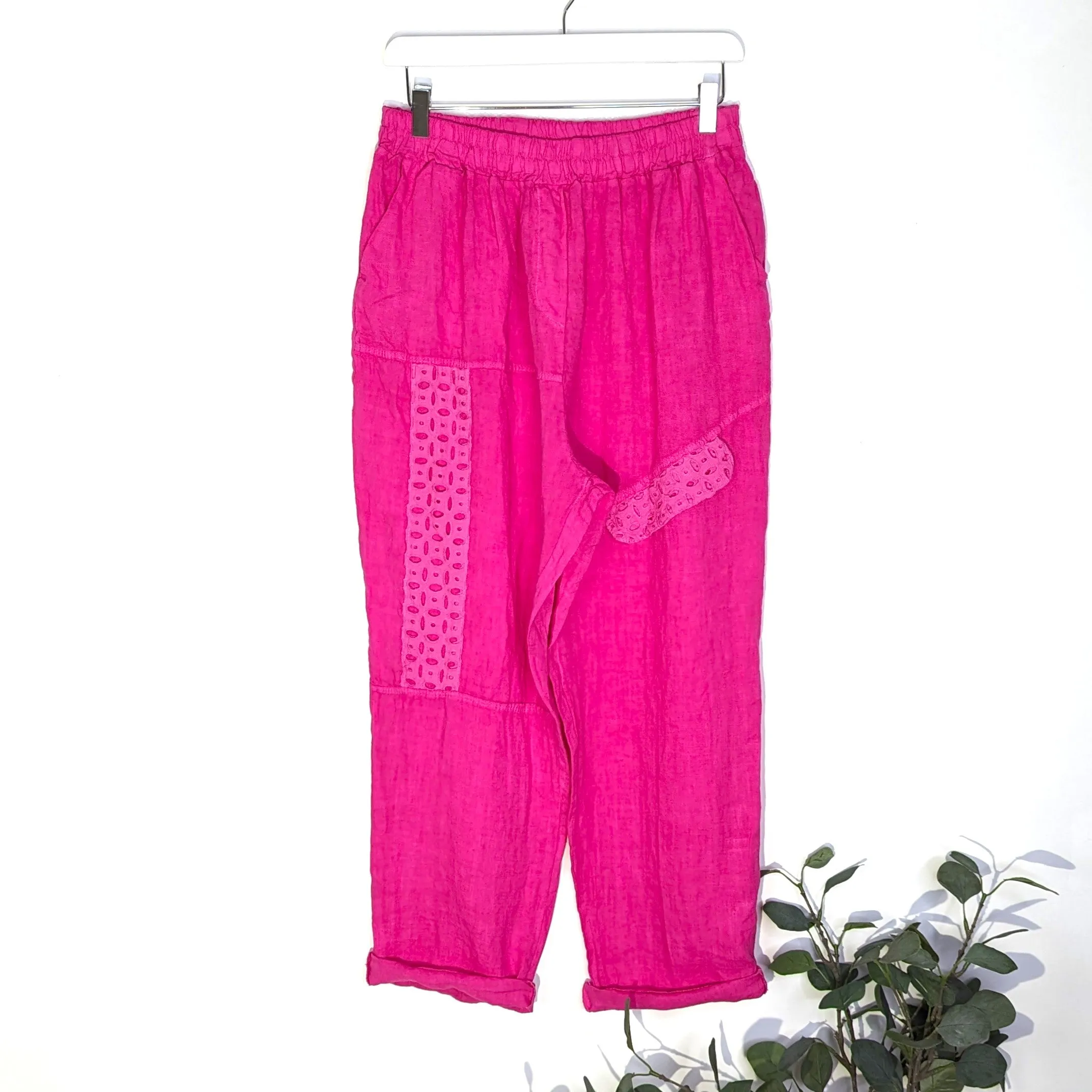 Linen trousers with embroidery anglaise elements on directional stitching with pockets
